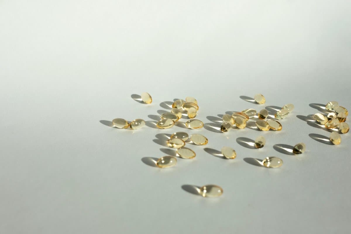 Supplement capsules scattered on a pale surface
